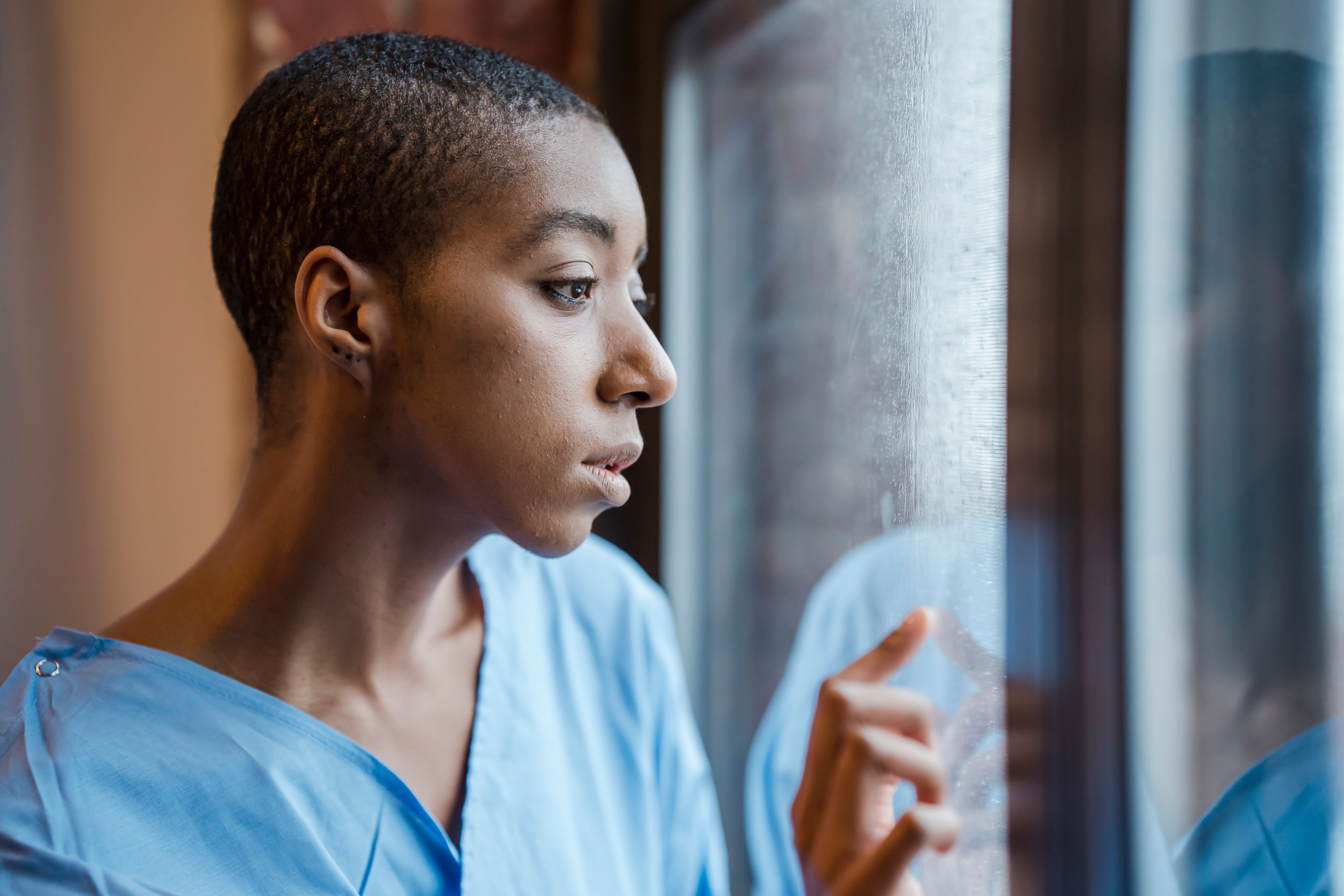 Patient sitting by a hospital window looking out